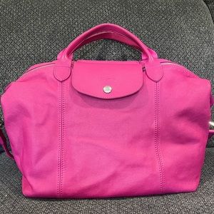 Longchamp pink leather handbag with crossbody strap.